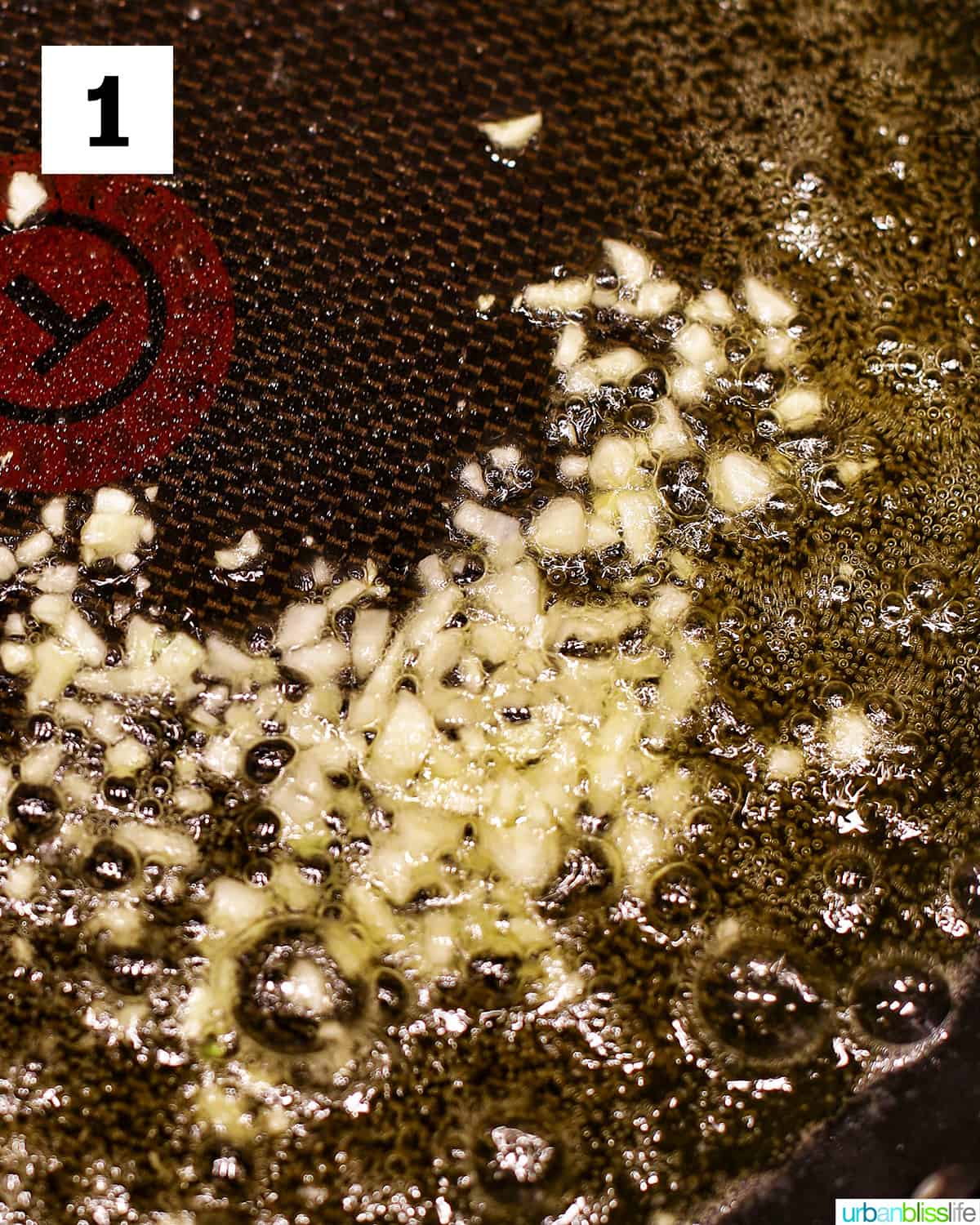 sauteing garlic in a skillet with olive oil.