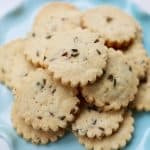lavender shortbread cookies piled on top of a cake pedestal