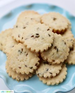 lavender shortbread cookies piled on top of a cake pedestal