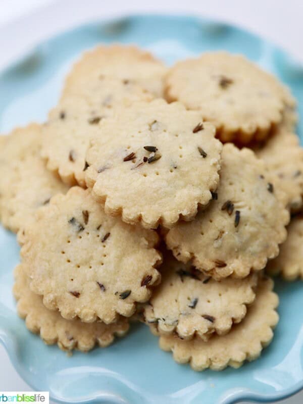 lavender shortbread cookies piled on top of a cake pedestal