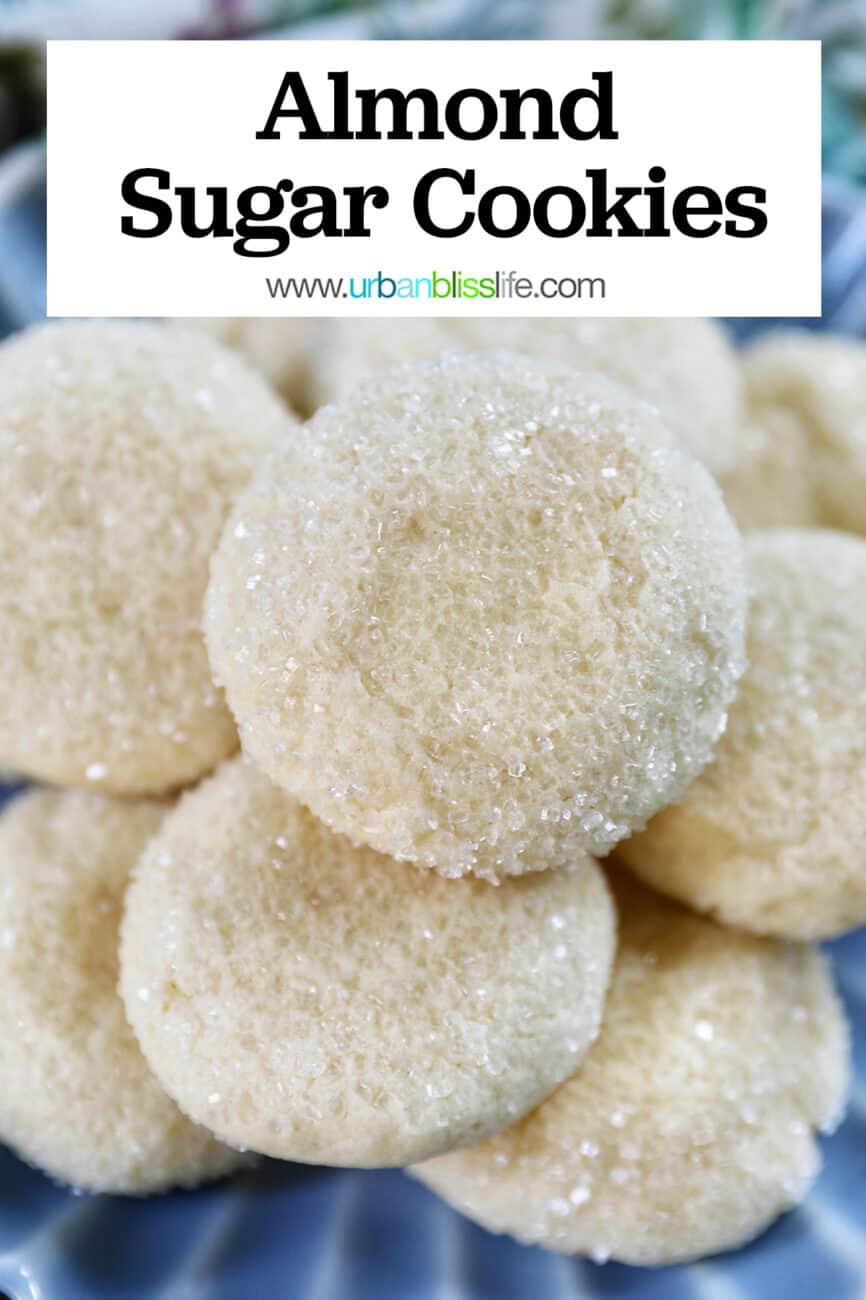 soft almond sugar cookies stacked on top of each other on a blue plate with title text overlay.
