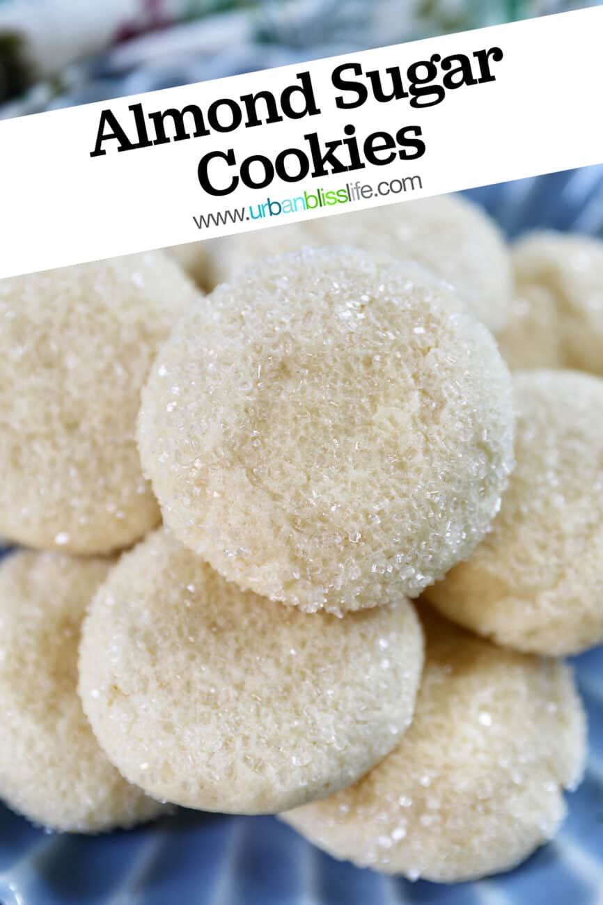 soft almond sugar cookies stacked on top of each other on a blue plate with title text overlay.