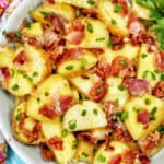 landscape photo of a bowl of baby potato salad with bacon with colorful napkin