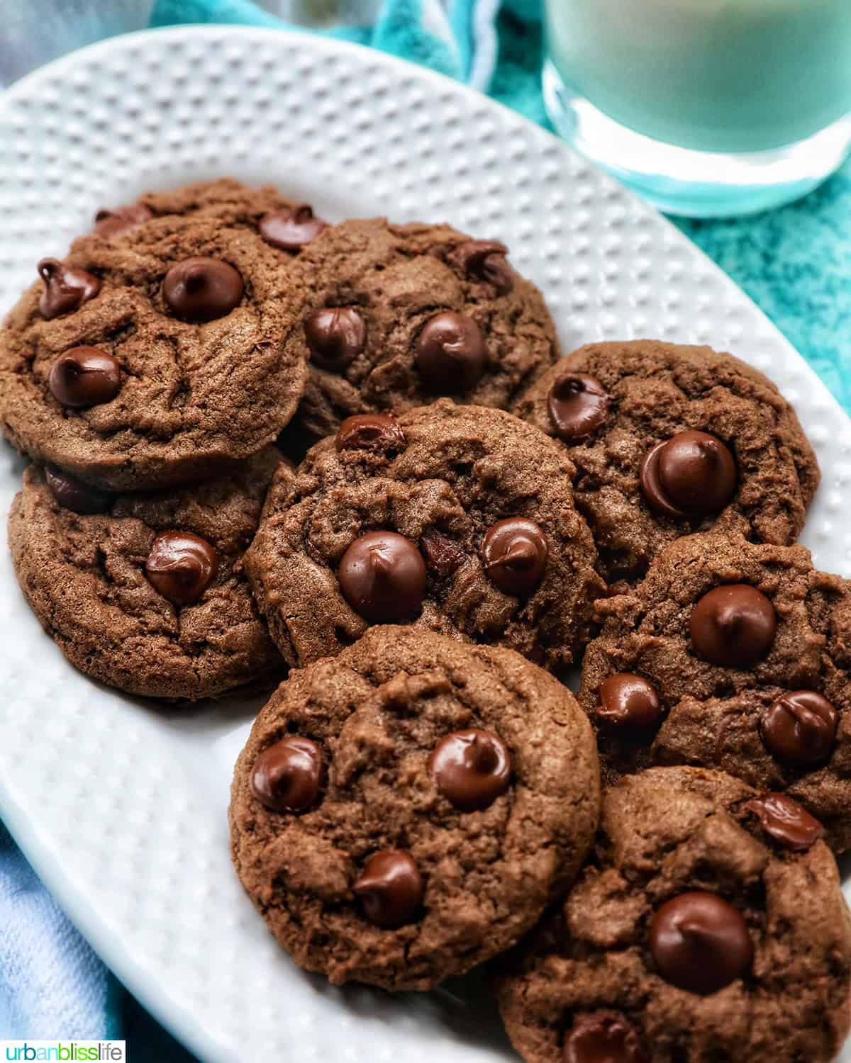 several double chocolate coffee cookies layered on a white plate.