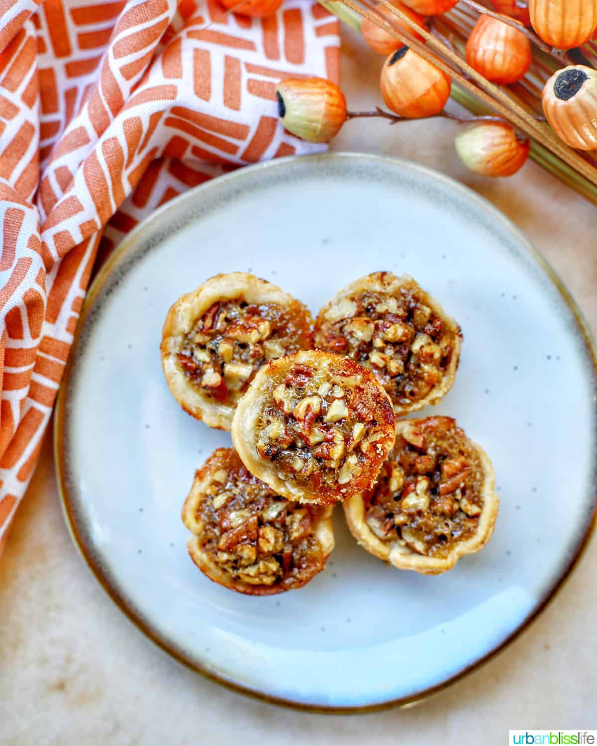 stacked mini pecan pies on a plate
