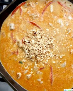 adding peanuts to the thai peanut curry