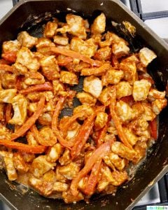 pork and red peppers in skillet