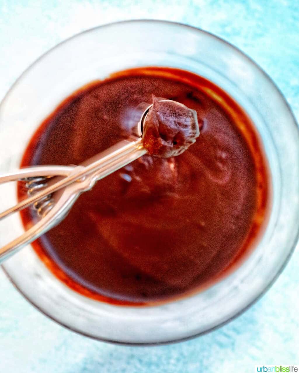 scoopng honey bourbon truffle dough from bowl.
