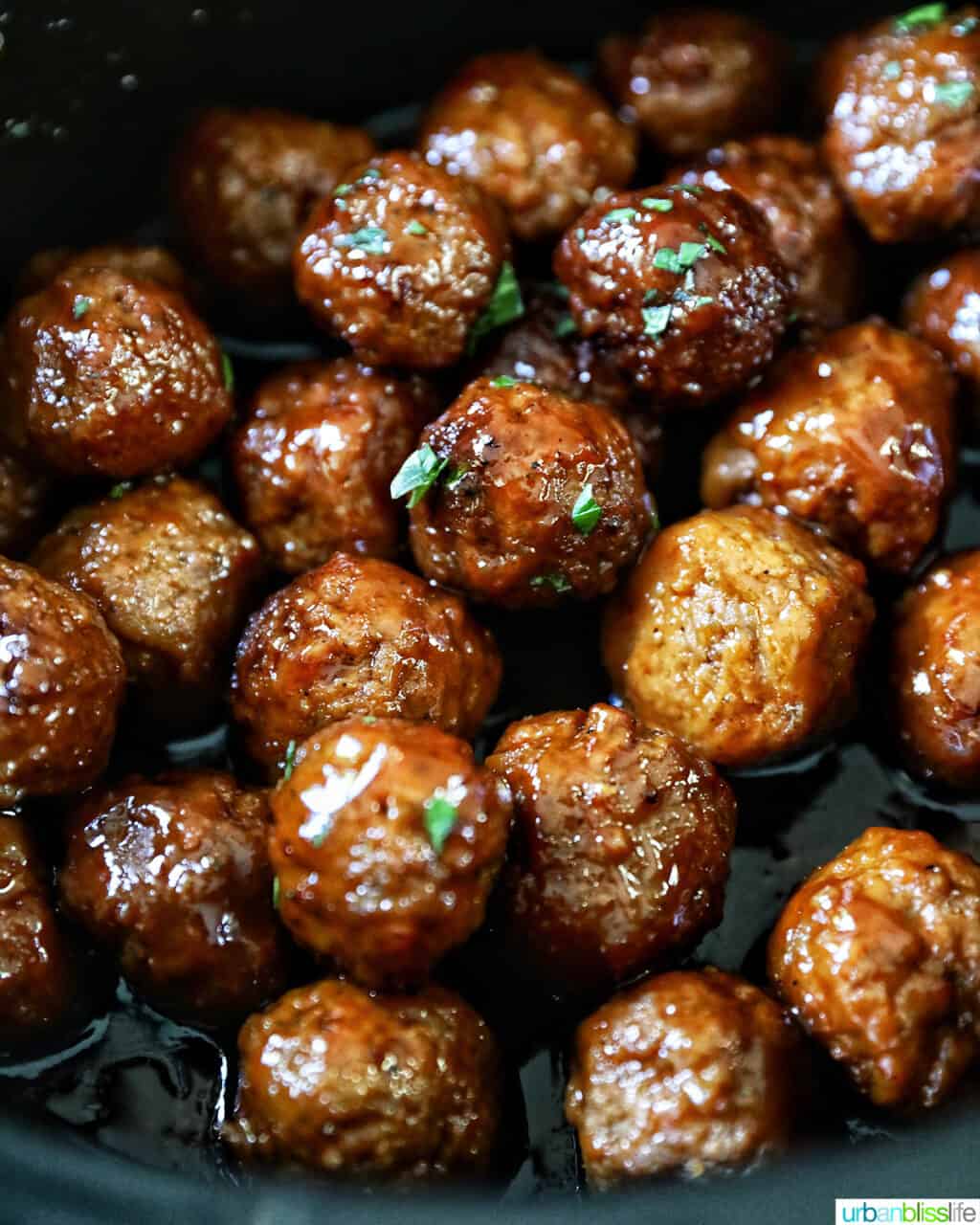 dozens of honey bourbon meatballs in a slow cooker.