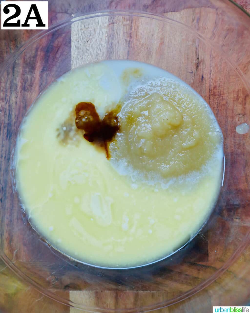 wet ingredients to make apple fritters in a bowl.