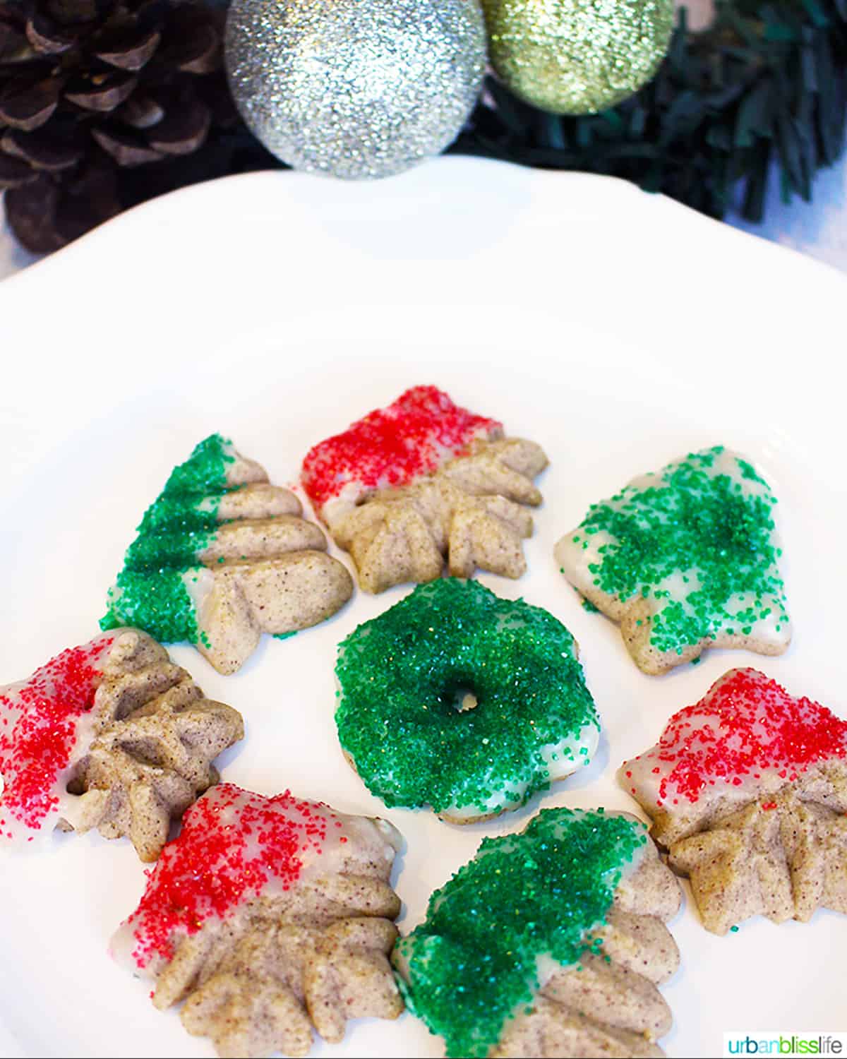 Red and green Cinnamon Christmas Spritz Cookies on a plate.