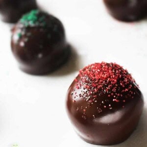 oreo truffles with red and green sugar sprinkles on top.