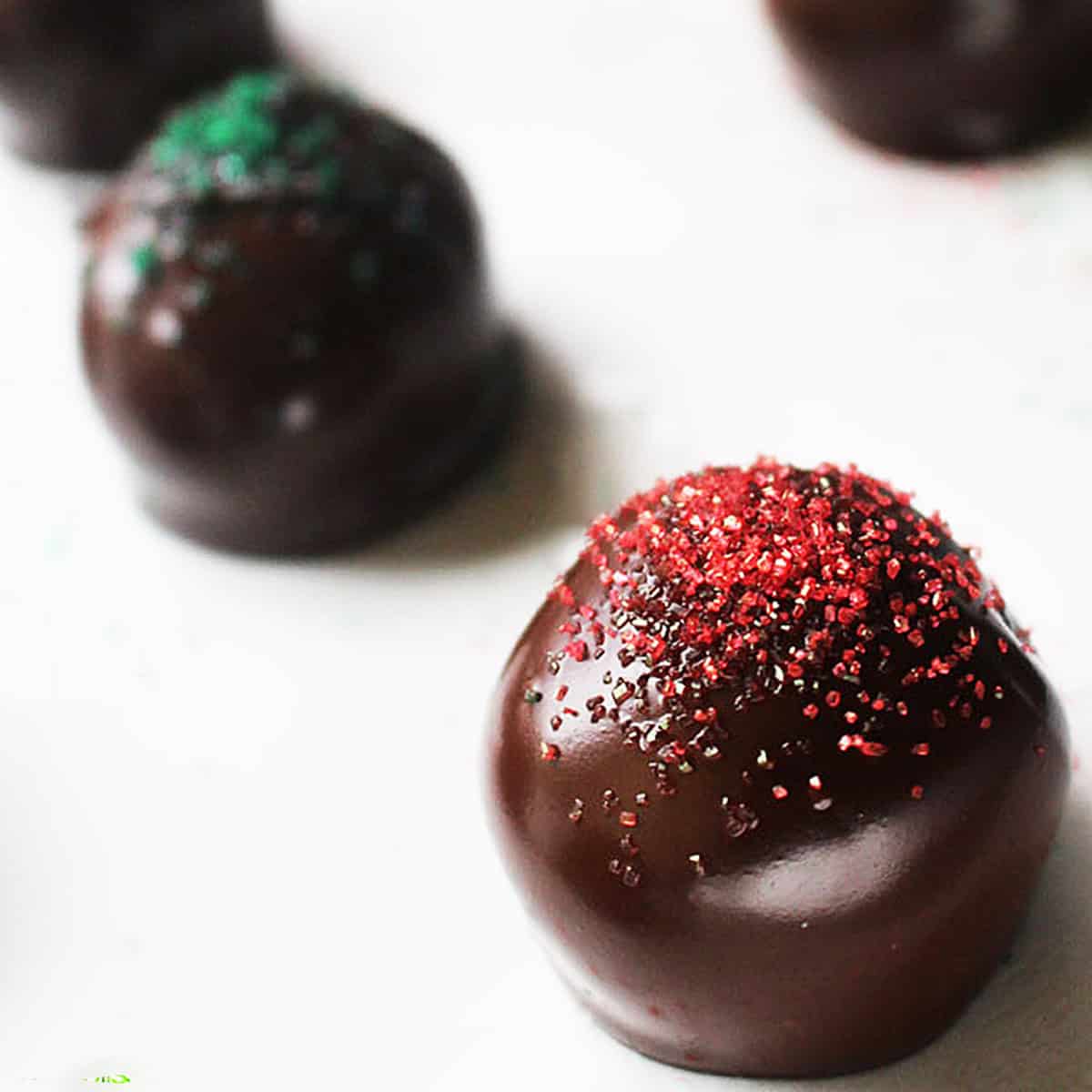 oreo truffles with red and green sugar sprinkles on top.