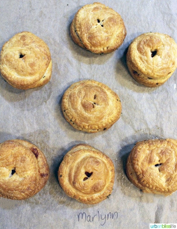 several Vegetarian Hand Pies just baked, on wax paper.