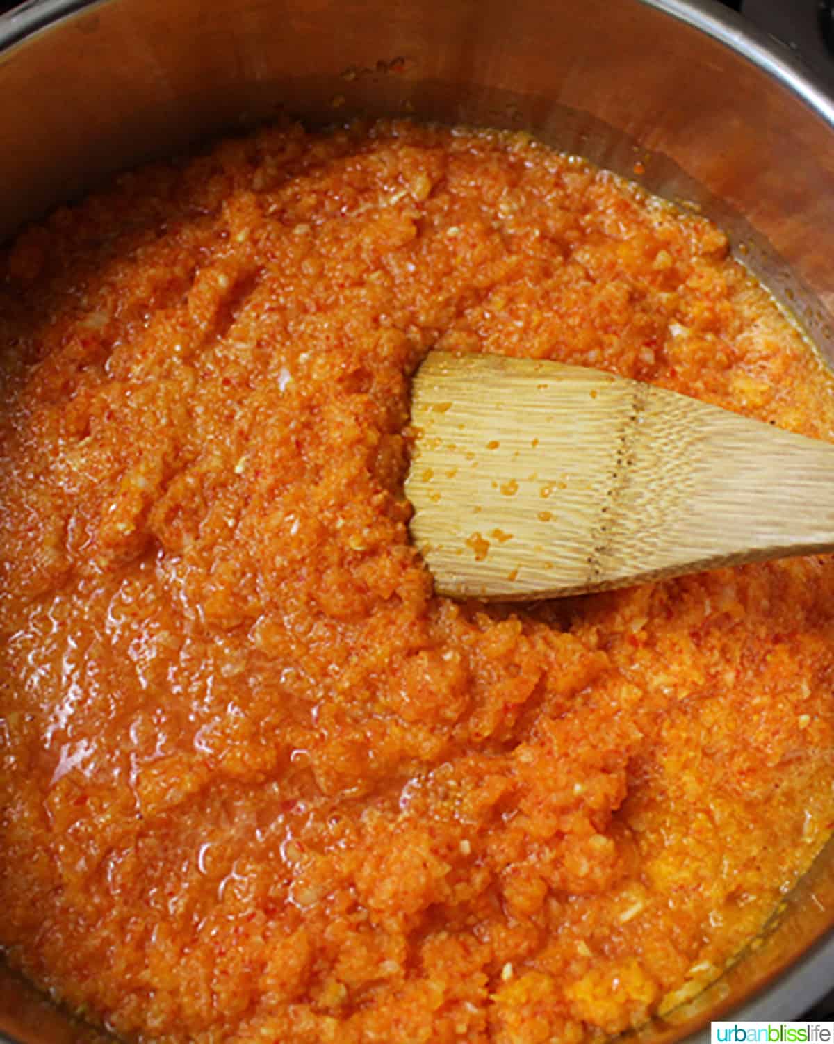 sweet chili dipping sauce in a pan with a wooden spoon.