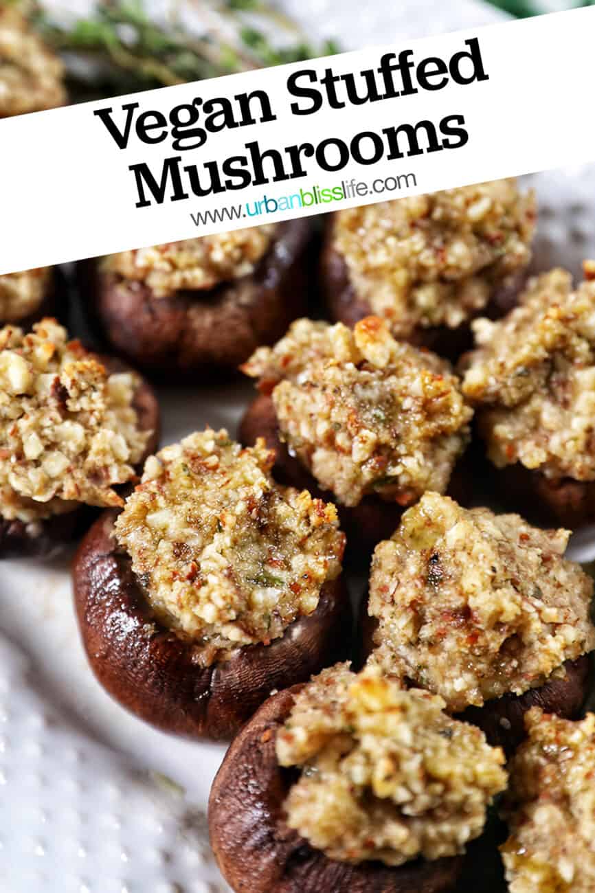 Vegan Stuffed Mushrooms close together on a white plate with title text overlay.