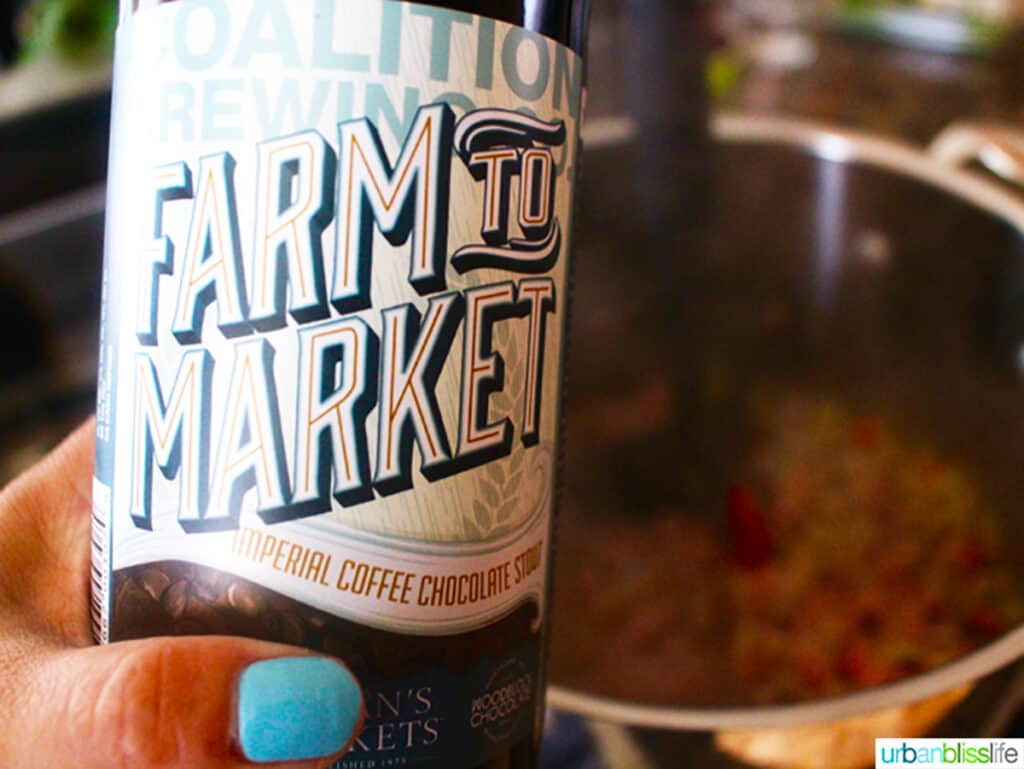 hand holding a coffee stout beer.