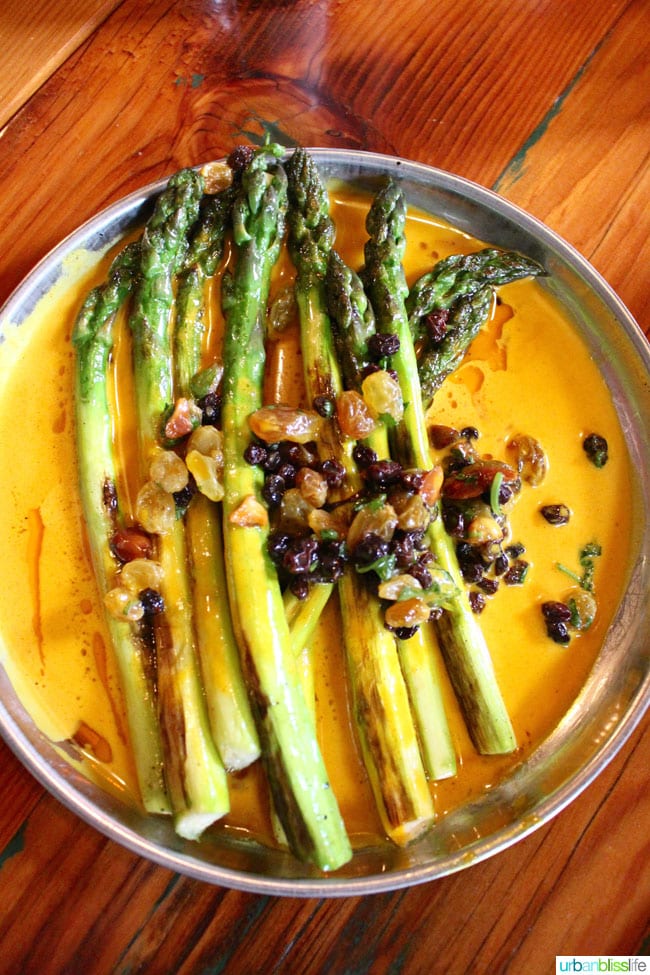 plate of grilled asparagus with green garlic and turmeric curry
