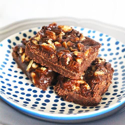 three salted caramel chocolate bars on a blue and white polka dot plate.