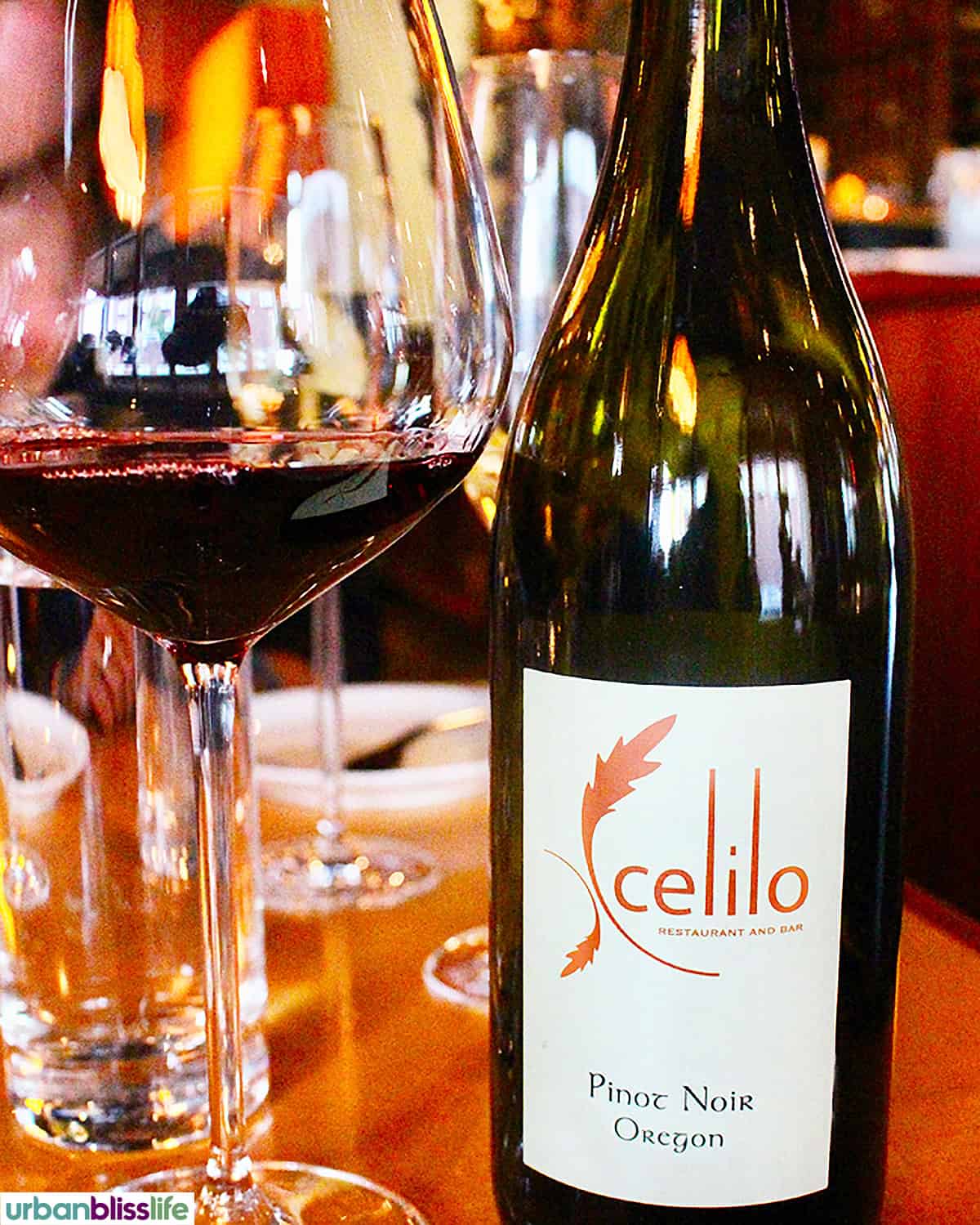 bottle of Celilo wine next to a glass of red wine.