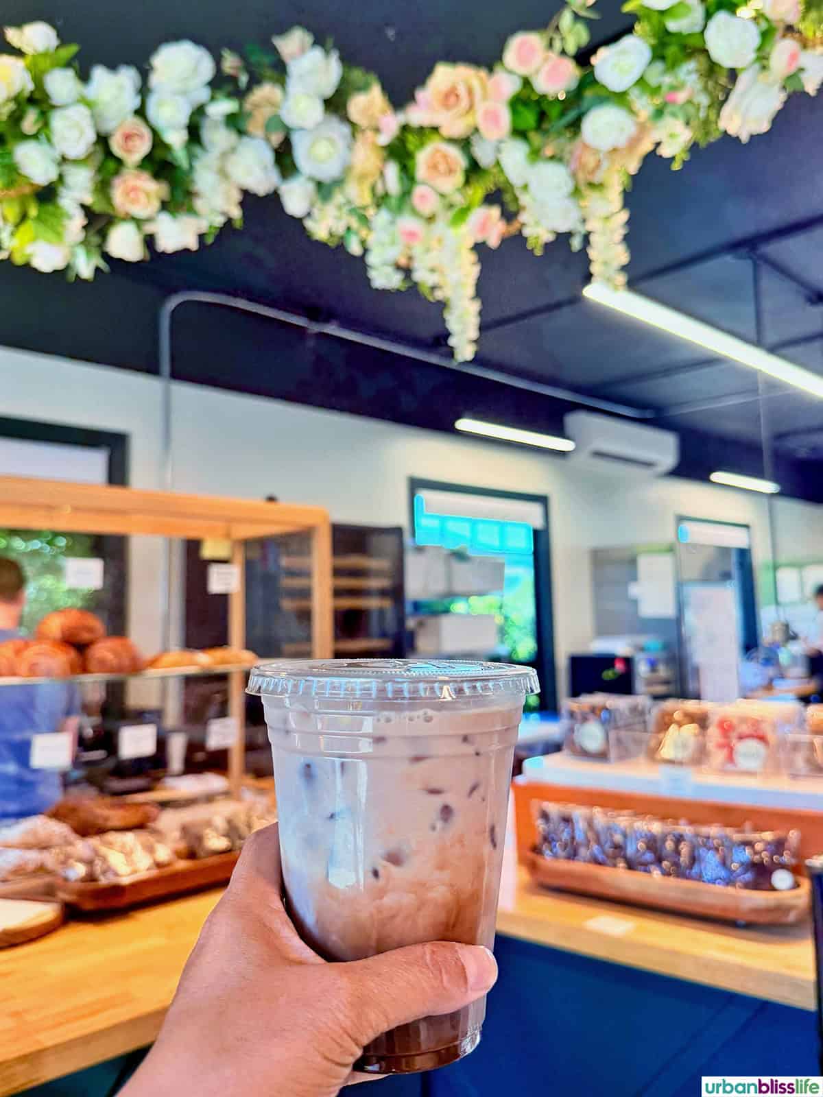 hand holding an iced coffee beverage at Edeske Patisserie in Hood River, Oregon.