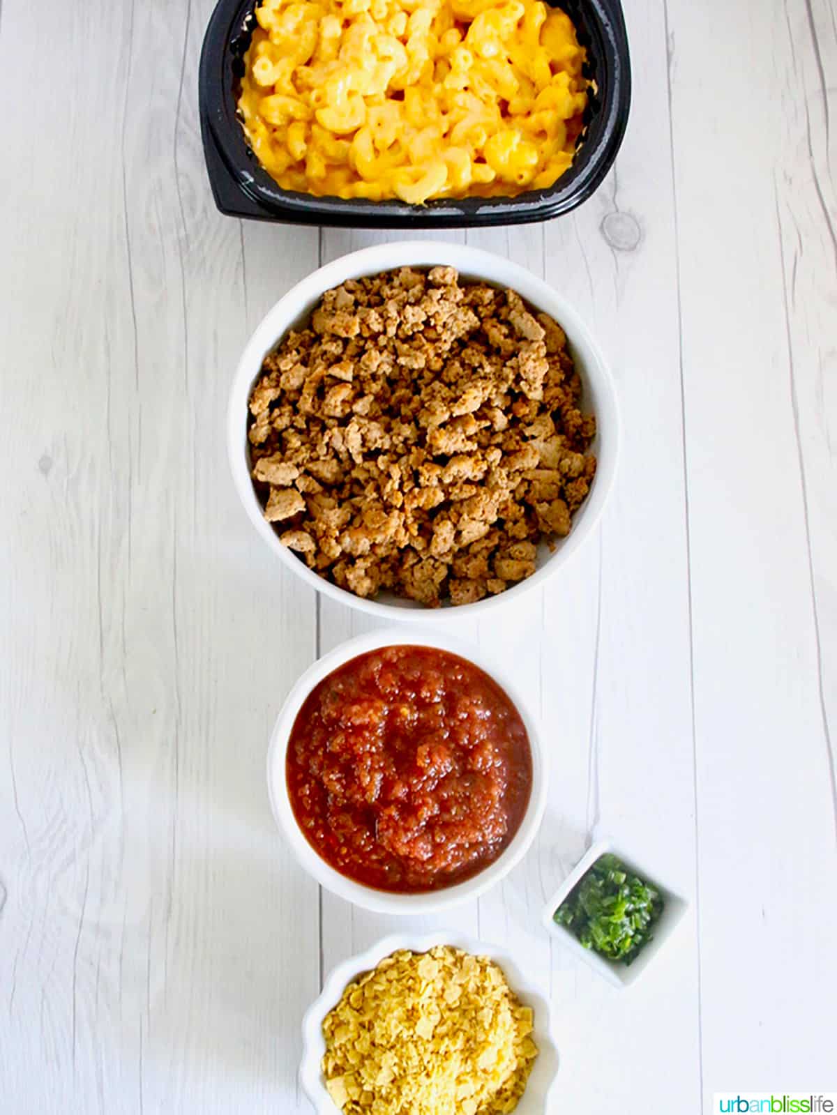 bowls of ingredients to make taco mac and cheese.