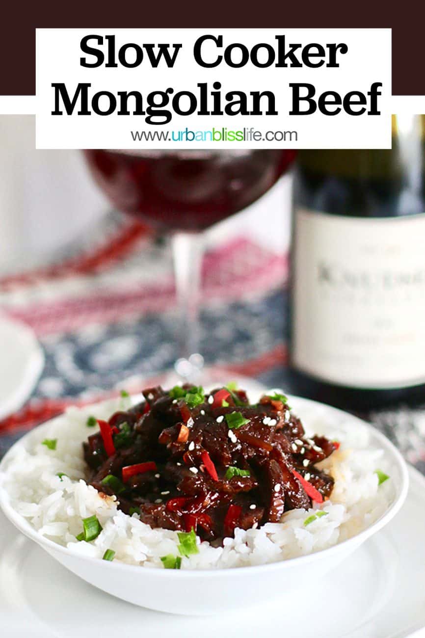 bowl of Slow Cooker Mongolian Beef with red wine and bottle
