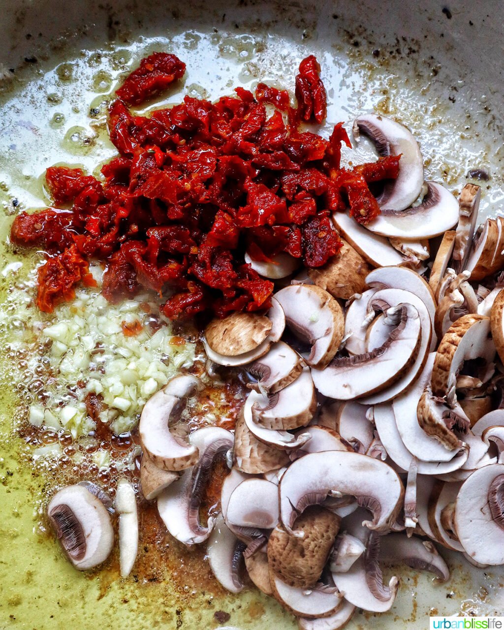 sundried tomatoes, mushrooms, garlic and olive oil in a pan.