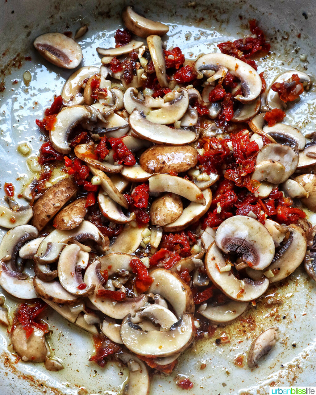 sundried tomatoes, mushrooms, garlic and olive oil in a pan.