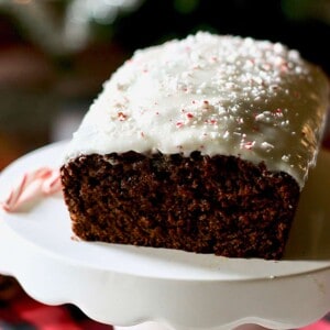 gingerbread loaf cake on a white plate with candy cane.