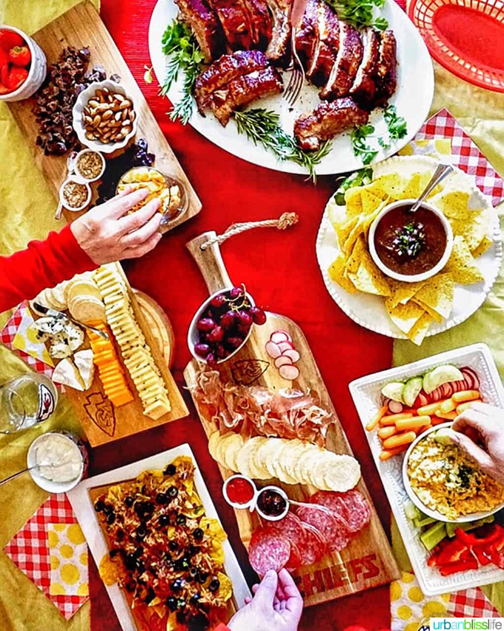 football game day food with instant pot pork ribs, pulled pork nachos, restaurant style salsa and chips, and more finger food on a red & yellow table.