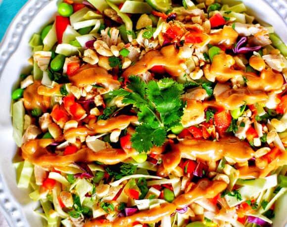 big bowl of Thai chicken salad with lime slices