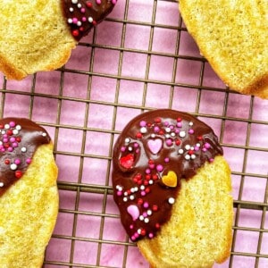 chocolate dipped madeleines on a cooling rack