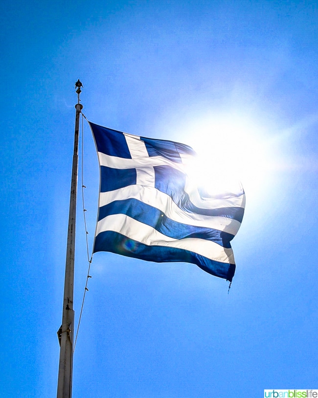Greek flag with sun shining behind it ยฉUrbanBlissLife.com all rights reserved