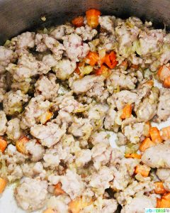 meat cooking with veggies for Sausage Tortellini Soup