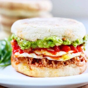 huevos rancheros breakfast sandwich on a plate.