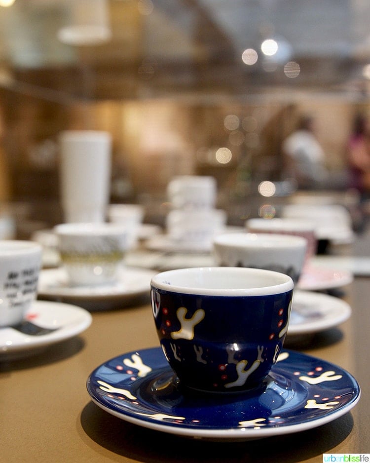 blue and white espresso cup with several espresso cups in the background.