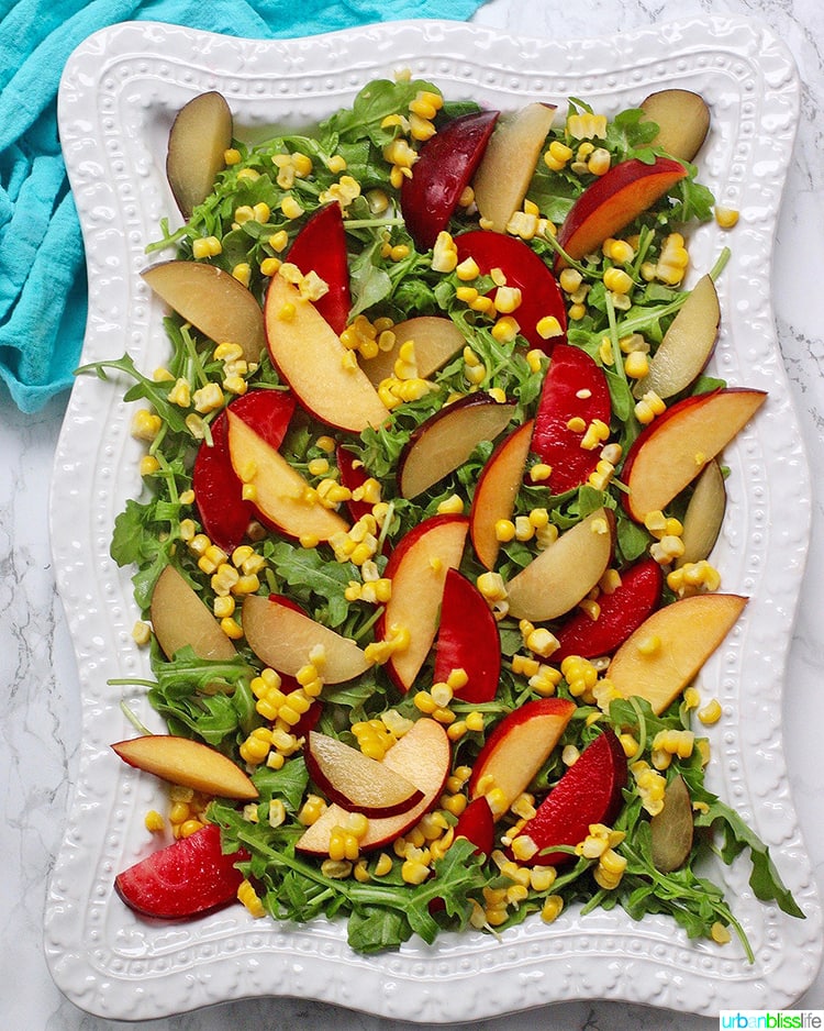 Peaches, Plums, Corn, Arugula salad plated