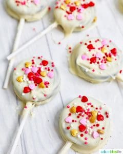 chocolate covered OREOs with pink and red heart sprinkles