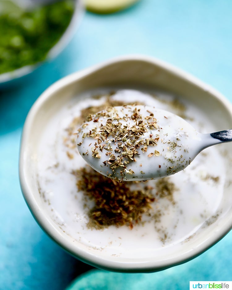 Greek herbs mixing into vegan tzatziki