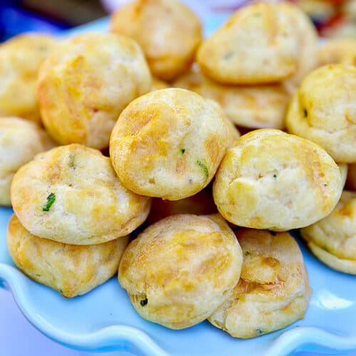 plate full of stacked gougere appetizers.