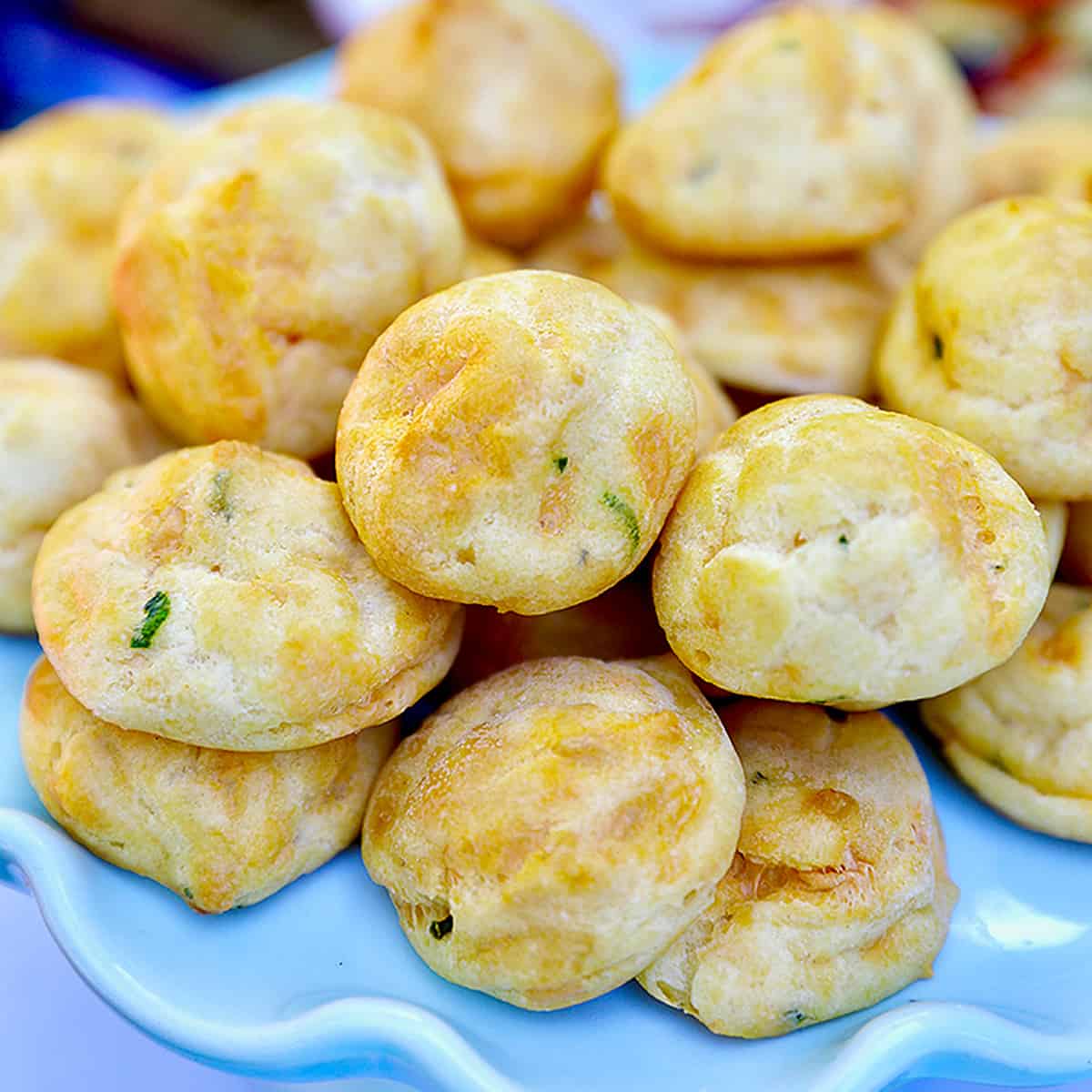 plate full of stacked gougere appetizers.