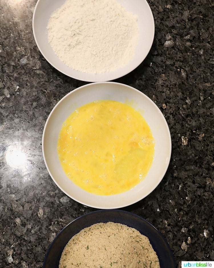 three bowls of breading for chicken tenders