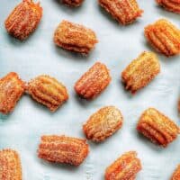 flatlay of churro bites sprinkled on a sheet