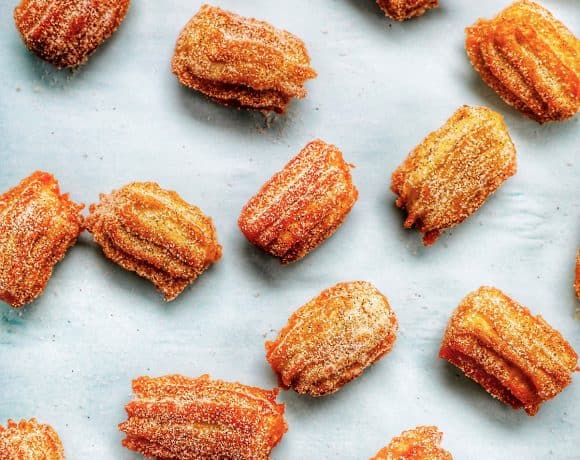 flatlay of churro bites sprinkled on a sheet