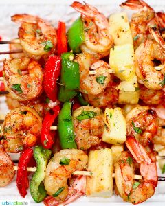 closeup of several grilled shrimp pineapple skewers served together