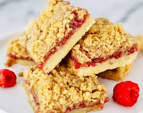 stack of Raspberry Crumble Bars on pedestal