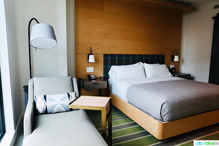 guest room bed & window seat in Canopy by Hilton Portland hotel