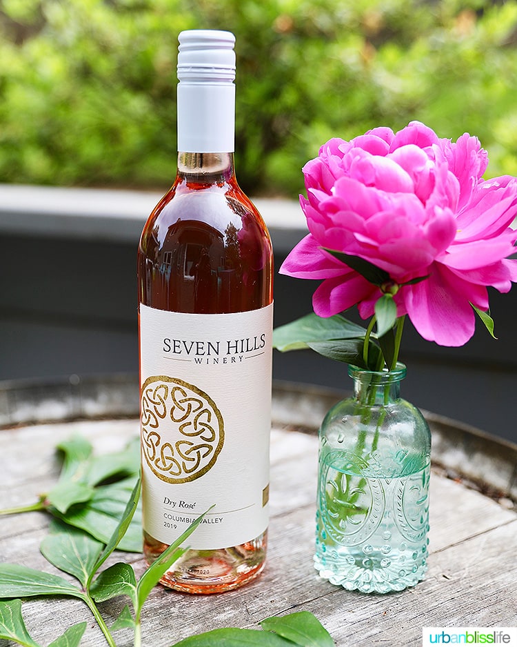 Seven Hills Winery 2019 Rosé wine bottle with pink flower in vase
