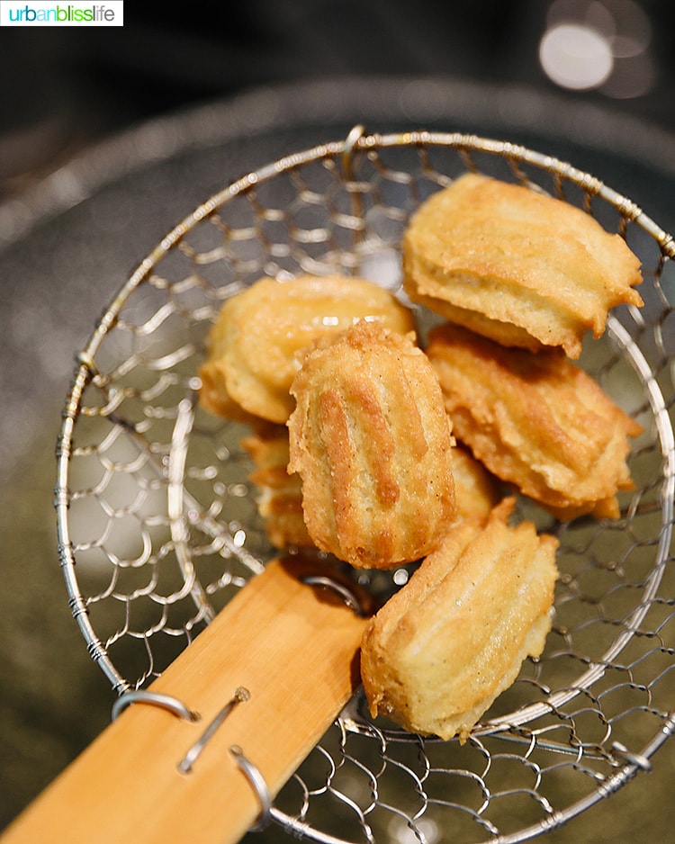 straining out cooked churros